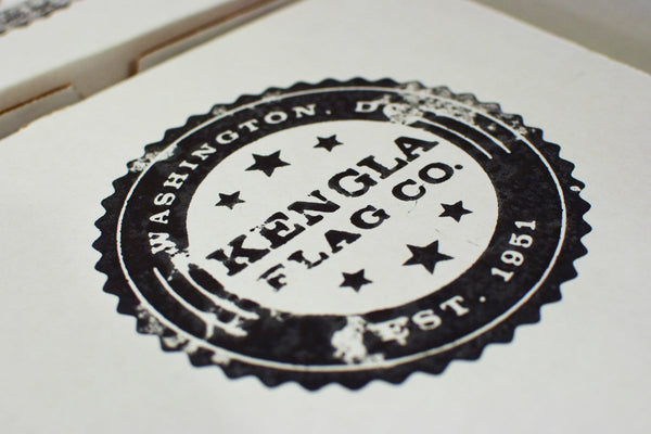 Vintage-style Kengla Flag Co. logo stamp printed on packaging.
