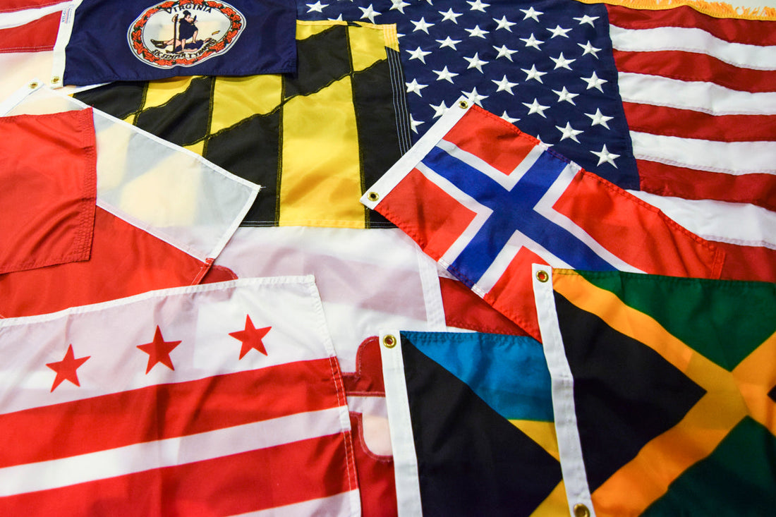 Collection of international and U.S. flags laid out together.