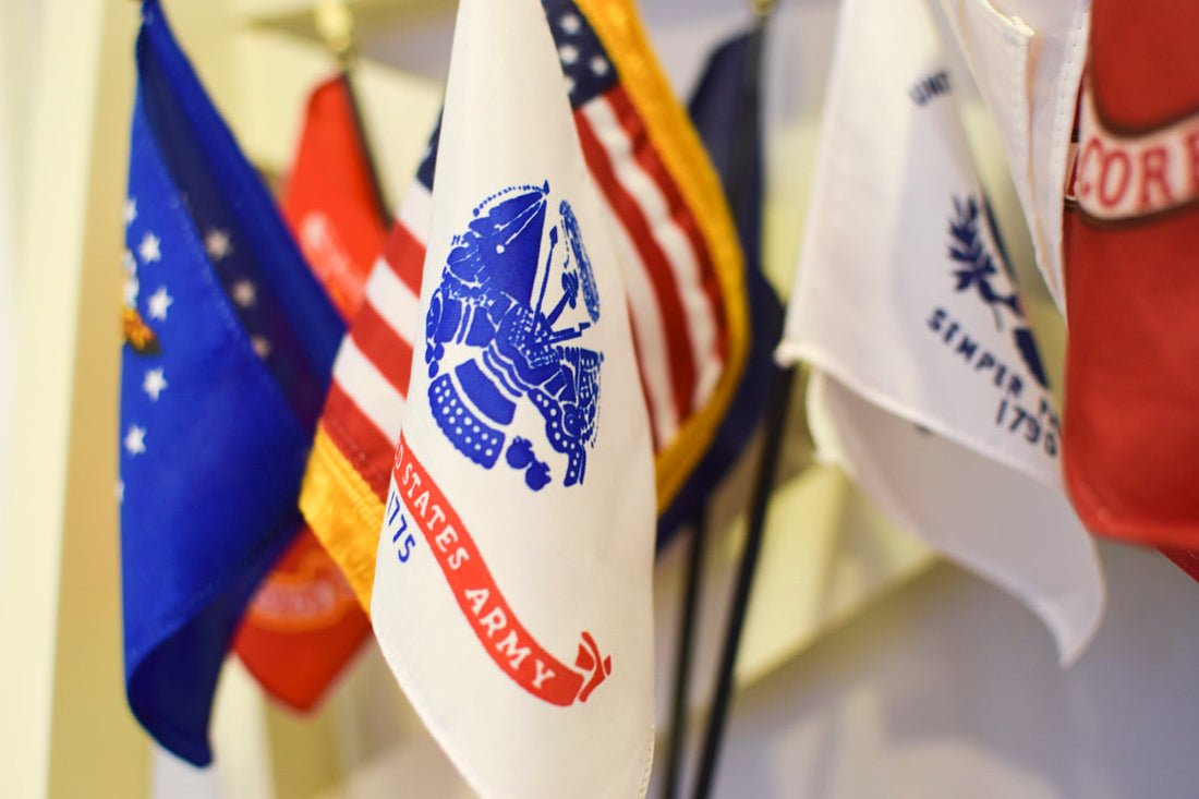 U.S. military branch flags displayed indoors for ceremonial honor at Kengla Flag Co.