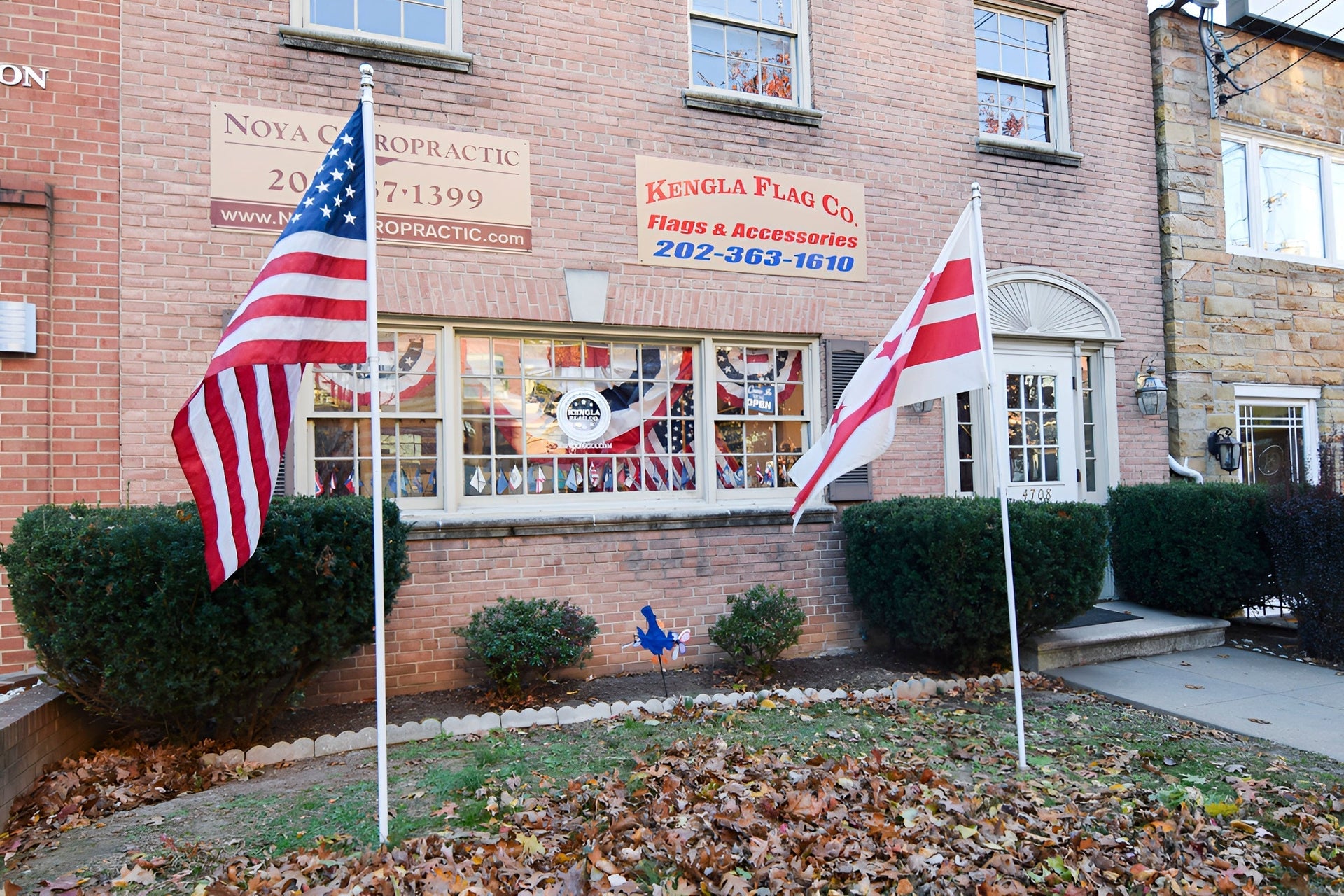 Exterior of the Kengla Flag Co. storefront with American and D.C. flags displayed in front.
