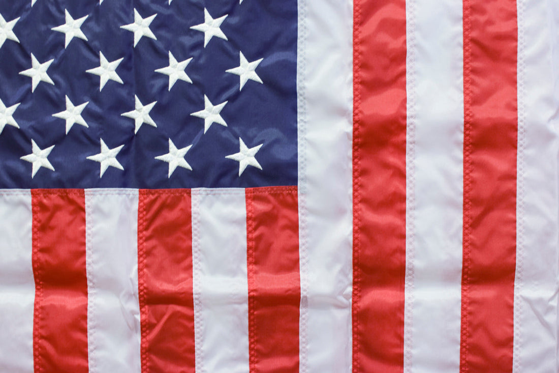 American flag showing white stars on a blue union and red-and-white stripes displayed outside Kengla Flag Co.
